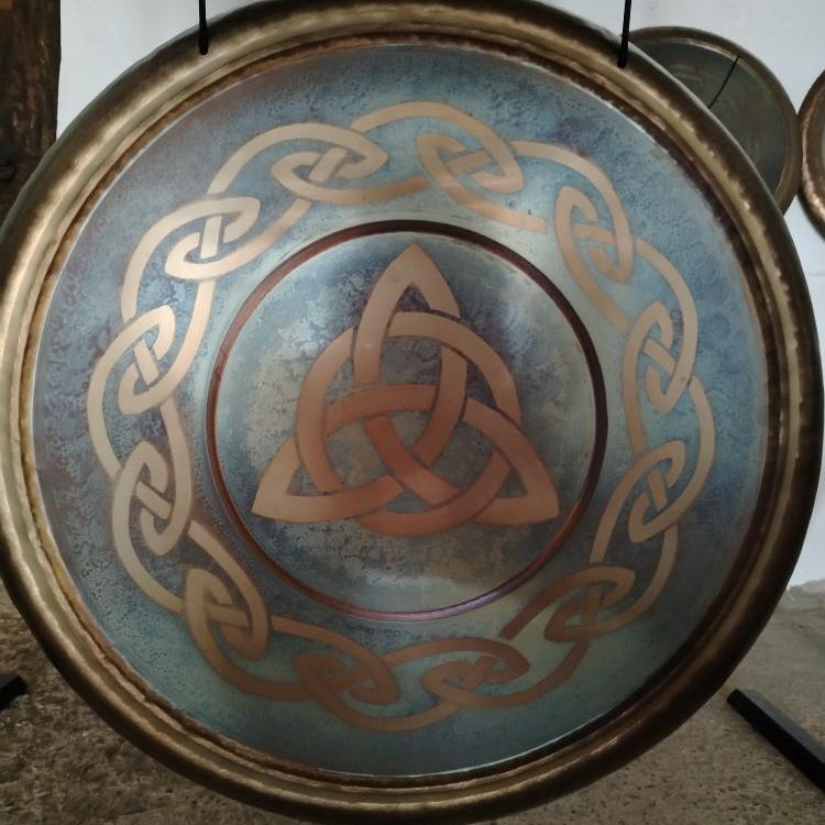 Decorative plate with Celtic knot design on a textured surface