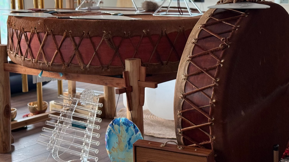 Large wooden drums with leather heads on a wooden floor.