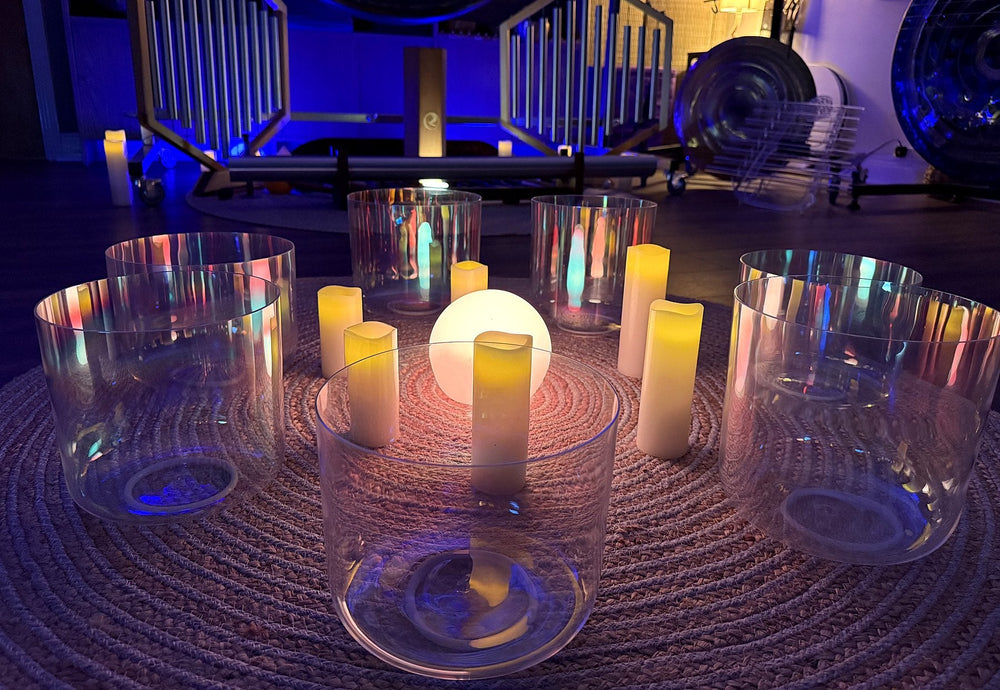 Crystal singing bowls in a circle around candles