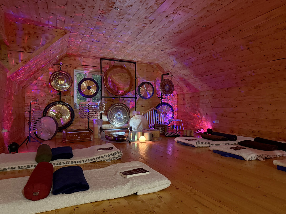 The training room set up for a sound session, with mats and gongs